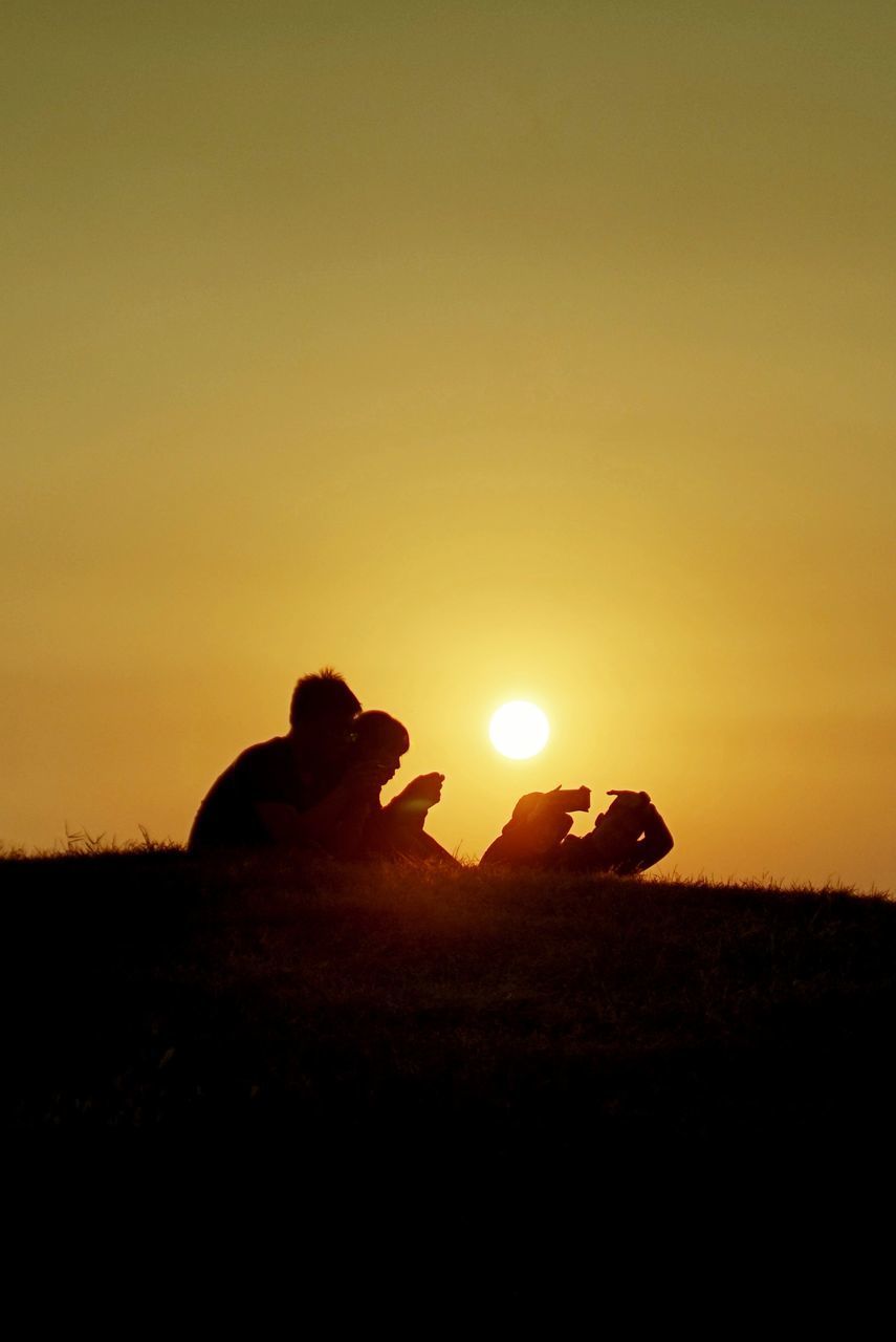 SILHOUETTE MAN ON FIELD DURING SUNSET