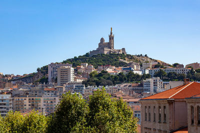 View of townscape against clear blue sky