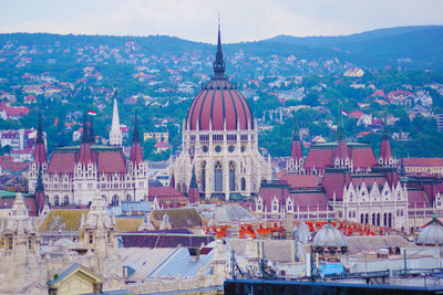 Aerial view of buildings in city against sky