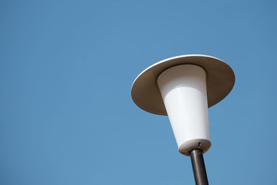 Low angle view of street light against clear blue sky