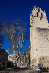 Low angle view of old building against blue sky