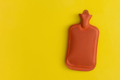 Close-up of mannequin against yellow wall