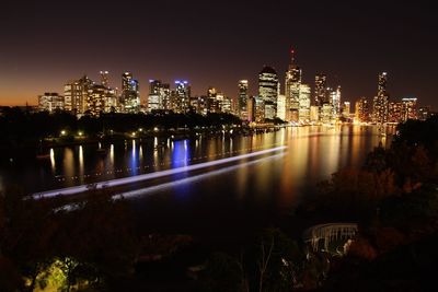 Illuminated skyscrapers reflection in brisbane river at kangaroo point