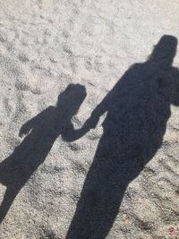 Shadow of people on beach