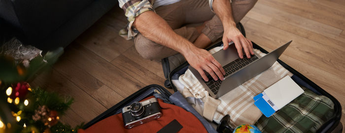 Midsection of man working on table