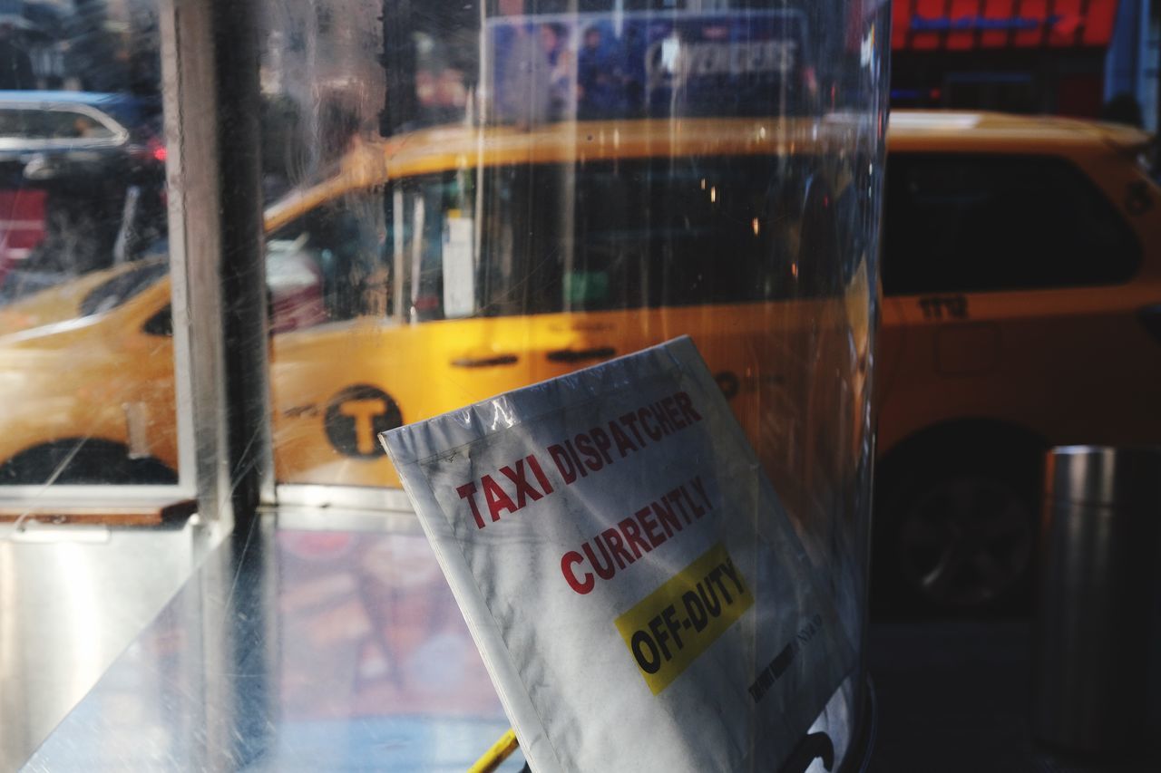 glass - material, text, communication, transparent, window, western script, mode of transportation, reflection, no people, transportation, land vehicle, public transportation, day, focus on foreground, close-up, architecture, bus, glass, sign, indoors, message
