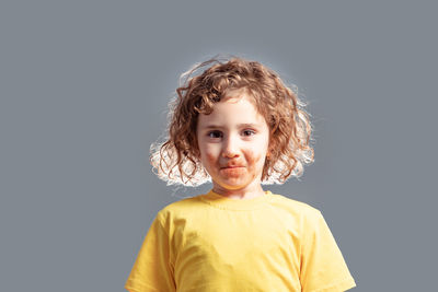 Portrait of boy against black background