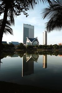 Building by swimming pool in city against sky