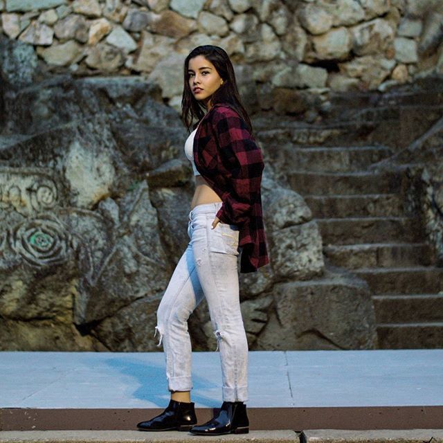 casual clothing, looking at camera, portrait, person, young adult, standing, full length, lifestyles, front view, young women, leisure activity, smiling, three quarter length, built structure, steps, architecture, brick wall, wall - building feature