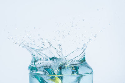 Close-up of splashing water against white background