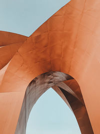 Low angle view of bridge and building against sky