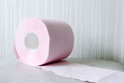 Close-up of paper ball on table against wall at home