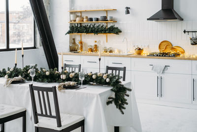 Christmas decor on the kitchen with garland. festive home interior. christmas table setting over