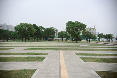 Park in city against clear sky