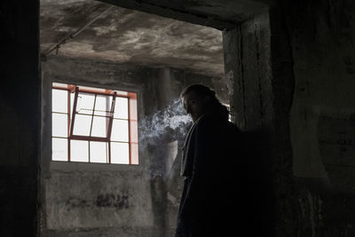 Man smoking in abandoned building