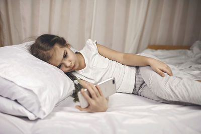 Young woman lying on bed at home