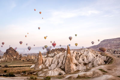 View of hot air balloons flying over rocks