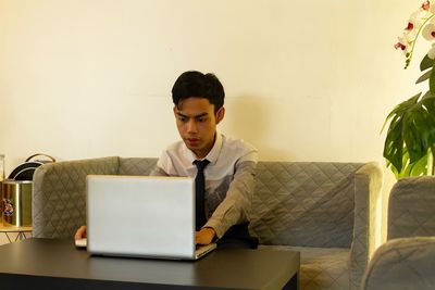 Young man using laptop at home