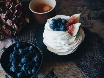 High angle view of pavlova and blueberries on table