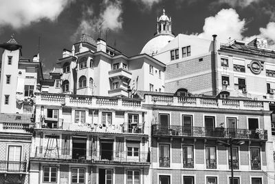 Low angle view of buildings in town against sky