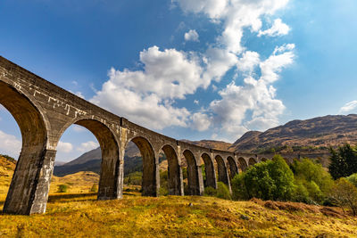 Low angle view of arch bridge against sky