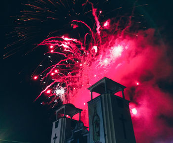 Low angle view of firework display at night