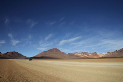 Scenic view of desert against blue sky