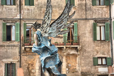 Statue against sky in city