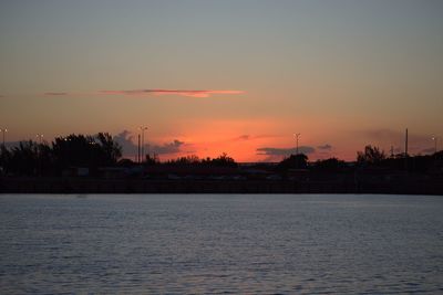 Scenic view of lake against romantic sky at sunset