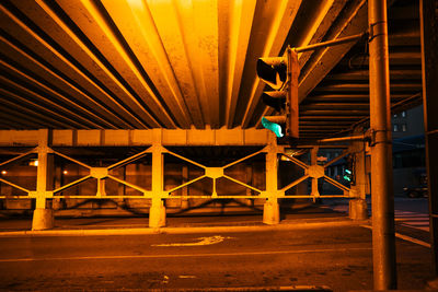 Illuminated bridge in city at night