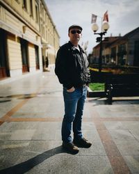 Full length of young man standing on city street