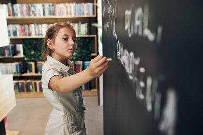 Student writing on blackboard. smart student put solve on chalkboard. back to school. learning