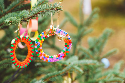 Handmade plastic decoration on christmas tree outdoors. diy ideas for children. environment, recycle