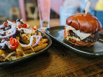 Close-up of burger and dirty fries on table