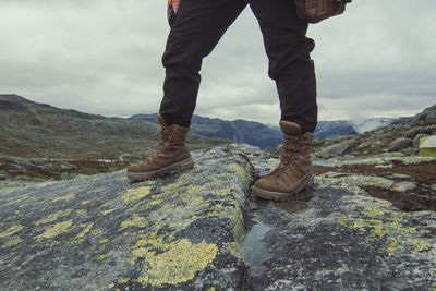 Tourist standing on stone at highland scenic photography