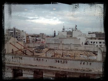 Buildings against cloudy sky