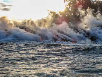 Lava emitting smoke in sea