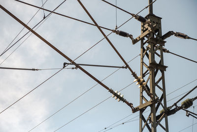 Low angle view of electricity pylon against sky