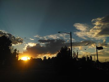 Silhouette trees against sky during sunset