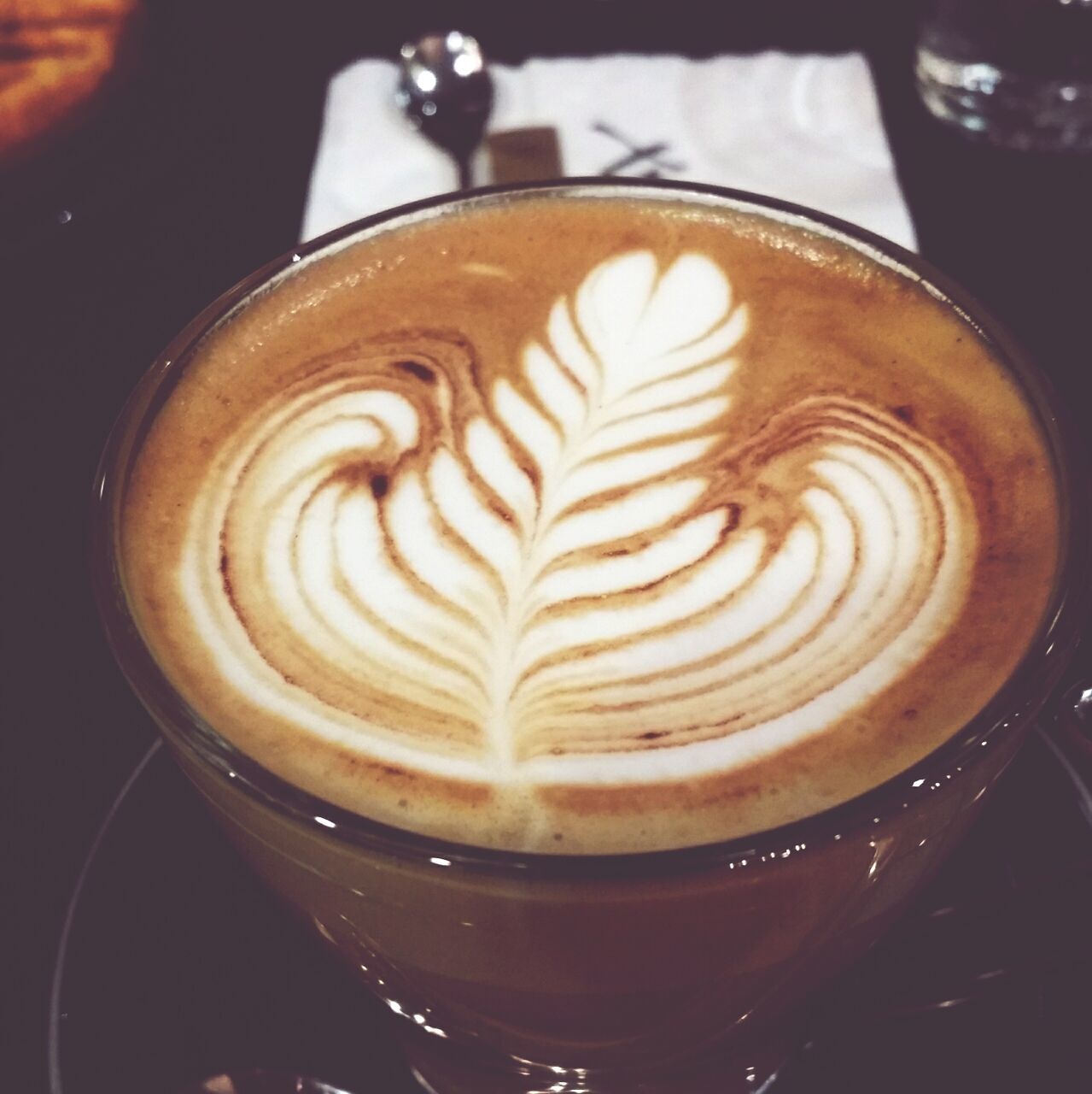 coffee cup, indoors, froth art, cappuccino, frothy drink, coffee - drink, refreshment, close-up, drink, food and drink, saucer, table, still life, high angle view, coffee, freshness, art, latte, creativity, spiral