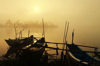 Boats moored of misty lake