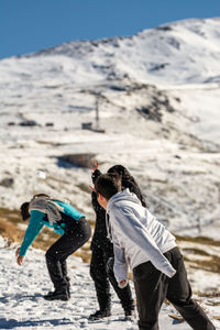 Latin family playing in the snow, ski resort, in grenada sierra nevada