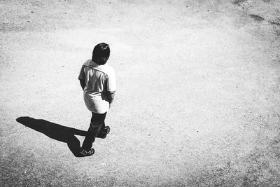 Full length of boy with arms raised