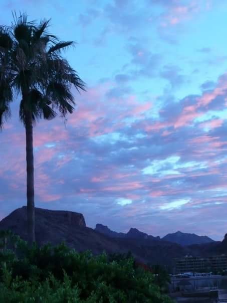 sky, mountain, sunset, tree, cloud - sky, scenics, palm tree, beauty in nature, tranquility, tranquil scene, silhouette, nature, cloud, cloudy, dusk, mountain range, built structure, idyllic, landscape, building exterior