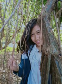 Young woman standing in forest