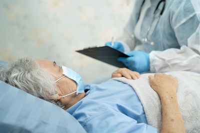 Side view of doctor examining patient at clinic