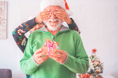 Rear view of woman holding gift