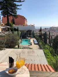 Chairs and table by swimming pool against building