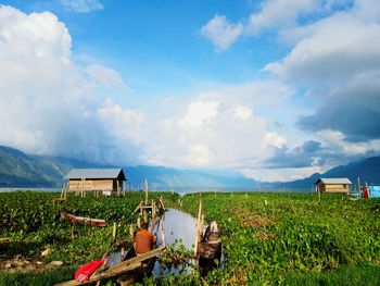 Barn on field against sky