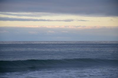 Scenic view of calm sea against cloudy sky